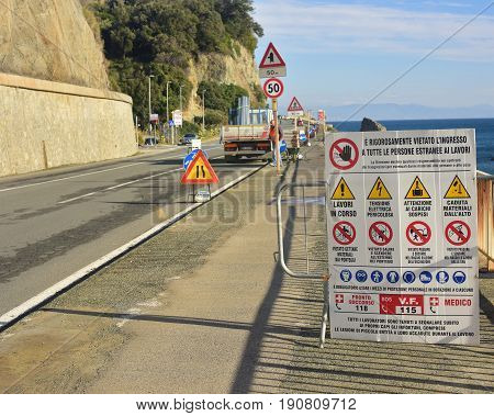 Road signs to warn motorists and pedestrians to pay attention to road works