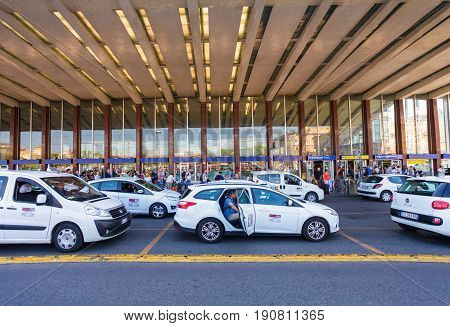 Rome Italy - September 12 2016: Taxi cars are near the taxi stop and queue from people at entrance of Termini Train Station in Rome