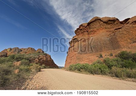 Dirt road leading over a high mountain pass in the daytime