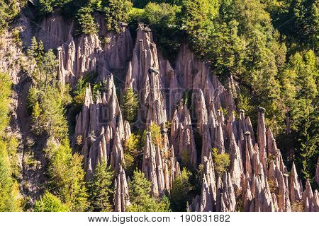  Journey to  magical fairy-tale country. Renon's earth pillars at sunrise. Magnificent Dolomites in Tyrol. The concept of ecological tourism 