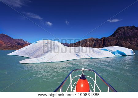 Ice and sun Patagonia. White-blue huge icebergs float near a ship board. Excursion on the tourist boat on Lake Viedma