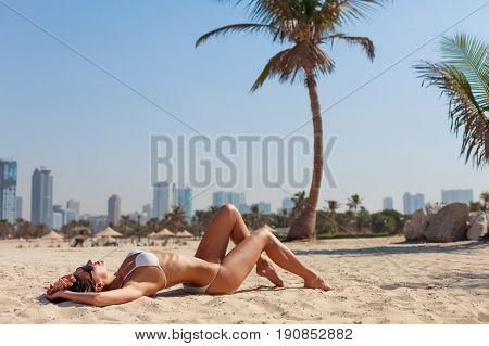 Sexy Beautiful Woman Lying Relaxing And Sunbathing In Bikini On Sea Background And Palm Tree. Panora