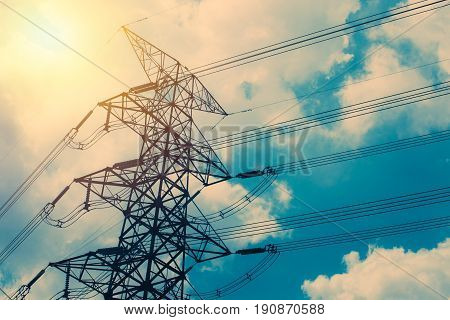 High Voltage Cable Power Post Steel Tower Pylons In Sunset Scene Twilight Vintage Color Tone.