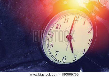 5 O'clock Vintage Clock At Dark Color Tone With Sun Light Memory Time Concept.