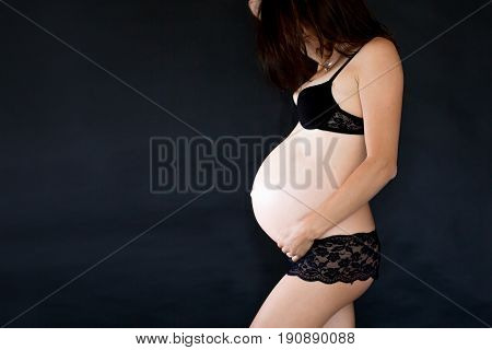 Portrait Of Beautiful Pregnant Woman, Isolated On Black Studio Background