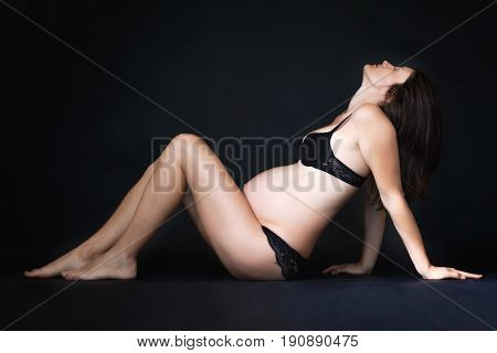 Portrait Of Beautiful Pregnant Woman, Isolated On Black Studio Background