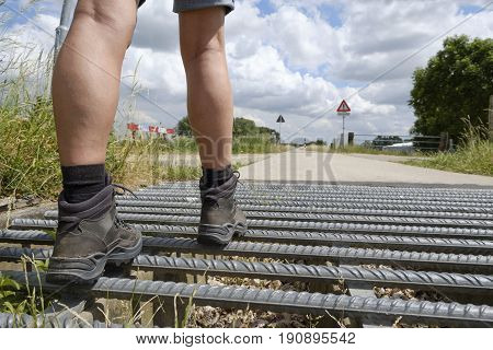 with heavy leather hiking boots walking across a cattle guard