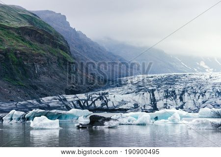 Evening landscape with ice floes in the glacial lake Fjallsarlon. Vatnajokull National Park, Iceland, Europe. Amazing tourist attraction. Art processing of photographs, color toning