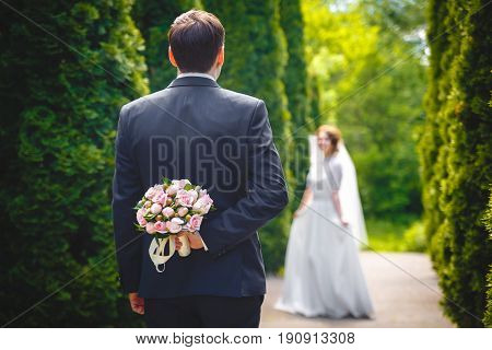 Beautiful bouquet of fresh flowers in hand of Bridegroome