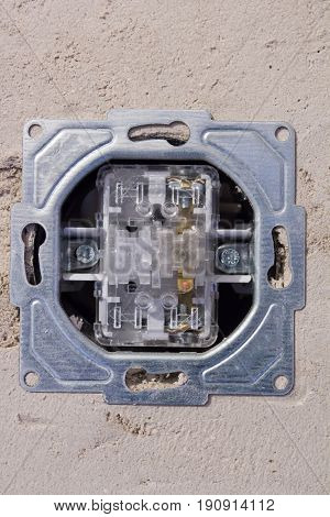 Open electric socket without front panel. Work on installing the wall outlet.