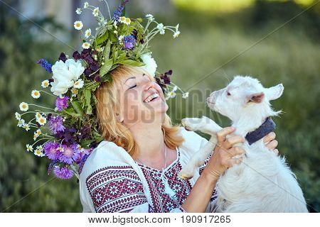 Funny picture a beautiful young girl farmer with a wreath on her