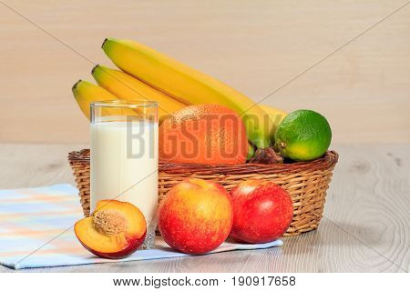 Glass Of Yogurt  With Mint And Fresh Strawberries, Nectarine, Lime, Banana, Orange On The Table