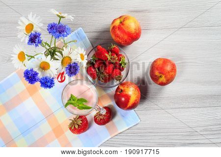 Strawberry Yogurt In A Glass With Fresh Strawberries, Nectarine, Chamomile, Cornflowers On A Wooden