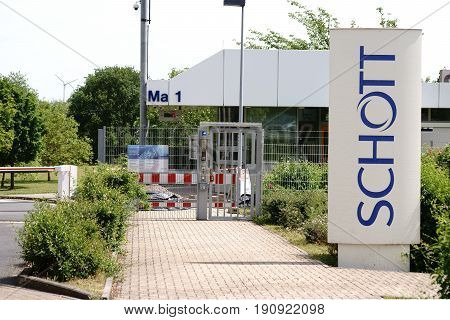 MAINZ, GERMANY - JUNE 08: The entrance gate and premises of the Schott AG in Mainz with a railway station on June 08, 2017 in Mainz.