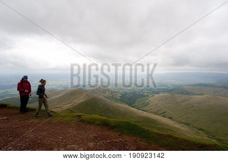 Wales, 14-08-2010: Two people hiking across the jaw dropping landscape of Wales.