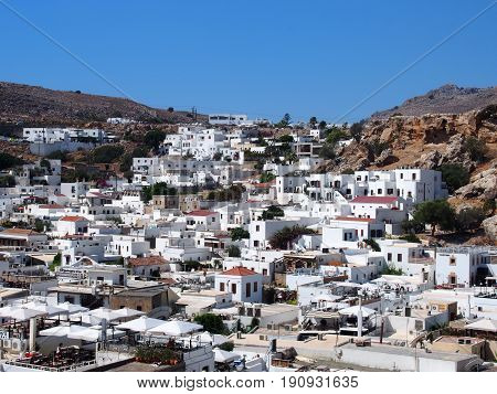 view of afandou village in rhodes with blue sky and mountains