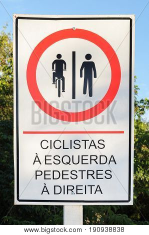 Info Board In Portuguese Signaling Where Cyclists And Pedestrians Should Walk.