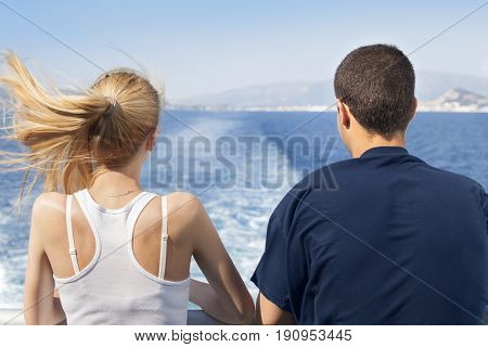 Young people woman and man sailing with ferry boat ship during their summer sea vacation.