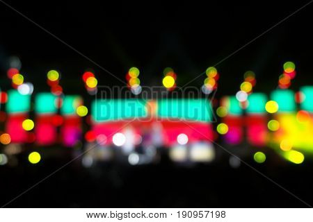 Defocused entertainment concert lighting on stage Festival event party night lights blurred abstract colorful bokeh background. multi color blur bokeh concert stage party at night.
