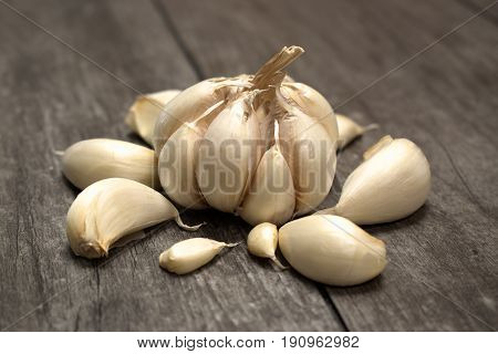 Fresh garlic violet isolated on wooden background.