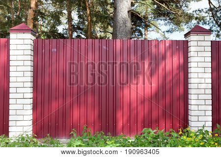 Fence Made Of Metal Panels Red Color Outdoors