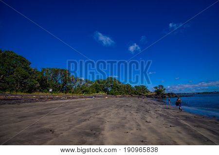 Beautiful view to Rangitoto Island from Karaka Bay Beach Auckland New Zealand in a blue sky in sunny day.