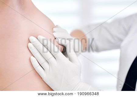 Cropped shot of a professional doctor examining breast of her female patient mammography mammalogy breast cancer awareness health medicine clinical concept.