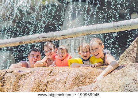 Happy adults and children in a water park.
