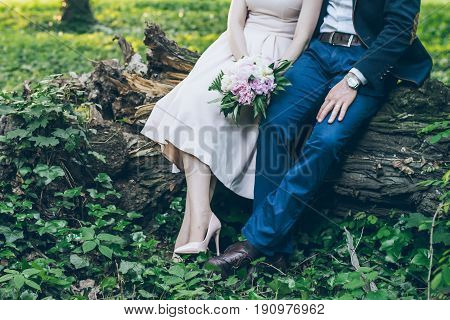 lovely cople sits in park on sunset