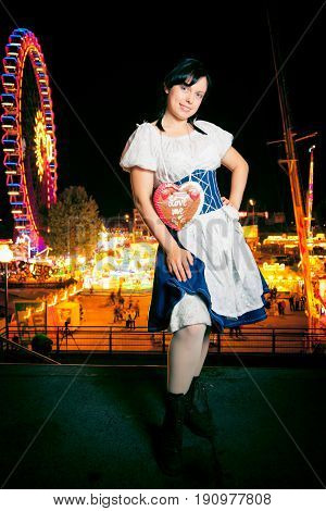 a young woman at the cannstatter wasen in stuttgart, an event very similar to the better-known 'oktoberfest' in munich.