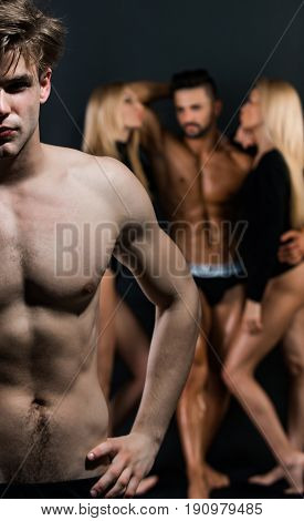 Man With Bare Chest Near Guy And Women