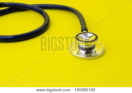 stethoscope on yellow background heart health care and medical technology concept selective focus copy space