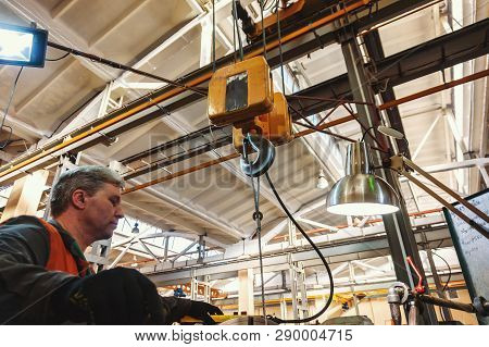 Turner Worker Manages The Metalworking Process Of Mechanical Cutting On A Lathe