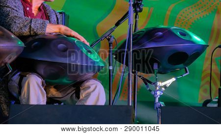 Man Playing Tank Drum Or Hang On Stage Of Ethnic Open Air Concert. Relaxation, Folk, Meditative And 
