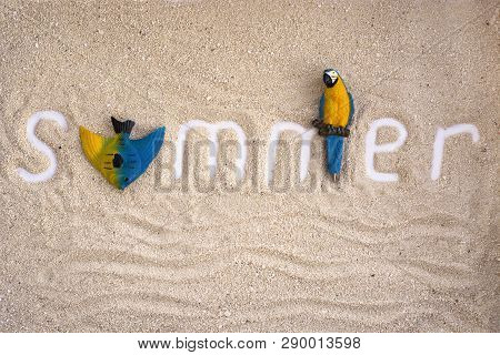 Summer Nscription On A Sand With Parrot And Fish. Summer Flatlay.