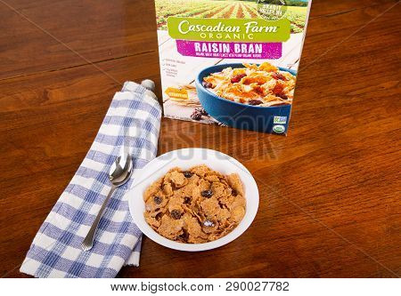 Atlanta, Georgia - April 19, 2017:  A Box Of Cascadia Farm Raisin Bran With A Bowl Of Cereal And Mil