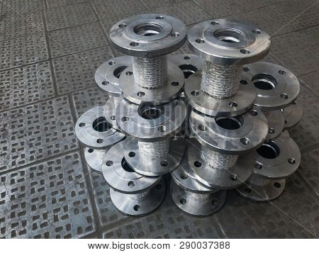 Bellows axial flange sylphon compensators. Metal sylphons on the factory metal floor