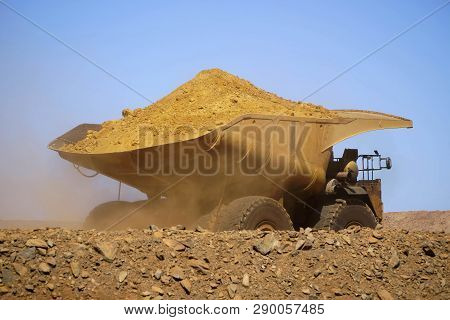 Gold Mine Operation In Open Gold Mine Pit With Large Haul Truck Leaving With Dirt