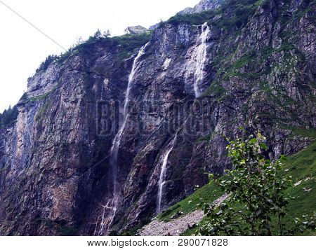 Waterfall Milchbachfall Or Wasserfall Milchbachfäll, Milchbäch Stream In The Alpine Valley Of Madera