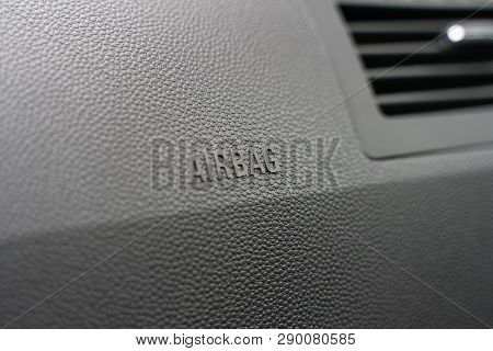Inscription On The Panel Of The Vehicle Airbag. Background Of Grey Textured Plastic Close-up