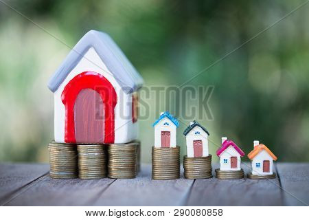 Mini House On Stack Of Coins,money And House,  Mortgage, Savings Money For Buy House And Loan To Bus