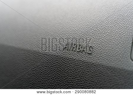 Inscription On The Panel Of The Vehicle Airbag. Background Of Grey Textured Plastic Close-up