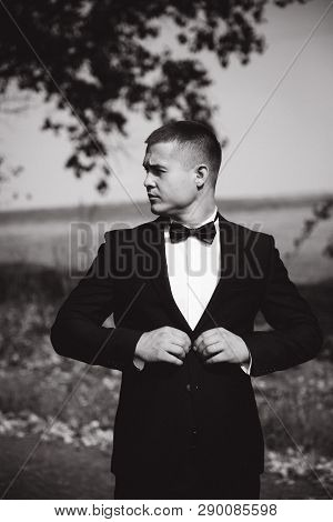 Handsome Groomm Dressed A Tie Bow. Wedding Day. Man Outside