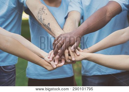 Volunteering, People, Team Spirit And Ecology Concept. Diverse Millennials Stack Hands Together, Clo