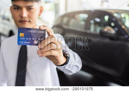 Asian Man Holding Credit Card For Car Blurred Bokeh Background E-shopping Marketing Digital, Consume