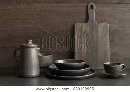 Crockery, Clayware, Dark Utensils And Stuff On Dark Tabletop. Kitchen Still Life.