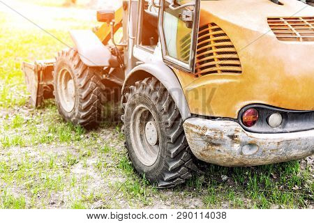 Wheel Loader Machine On Grass Field In Park Area. Municipal Works On Reconstruction And Renewal City