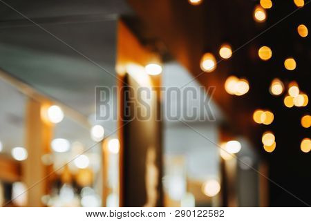 Burning Bulb Shines Weakly On The Background Blurred Yellow Lights