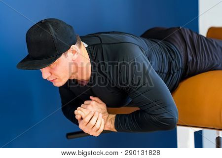 Portrait Of Male Athlete Doing Abs Exercise In Gym