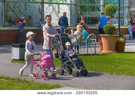 Kaliningrad, Russia - May 21, 2016: Unknown Mother With A Baby Carriage Strolls Along With The Child